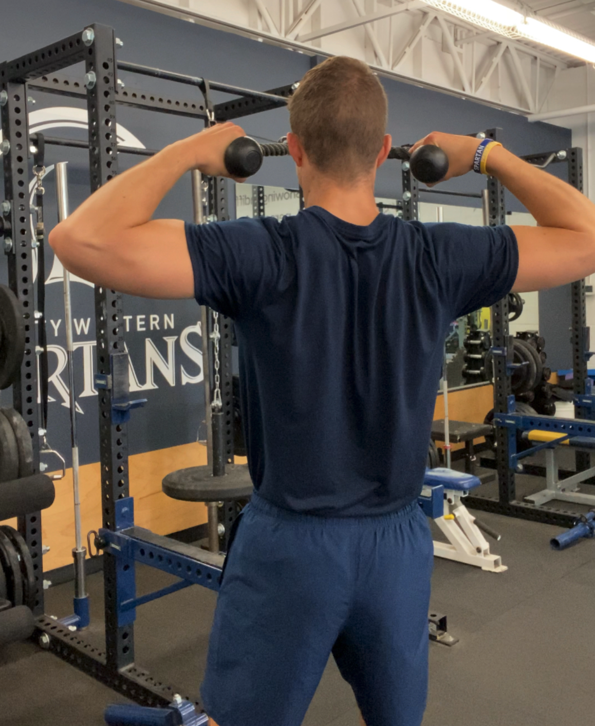 Man in Gym Showing Final Position of Face Pull Showing External Shoulder Rotation