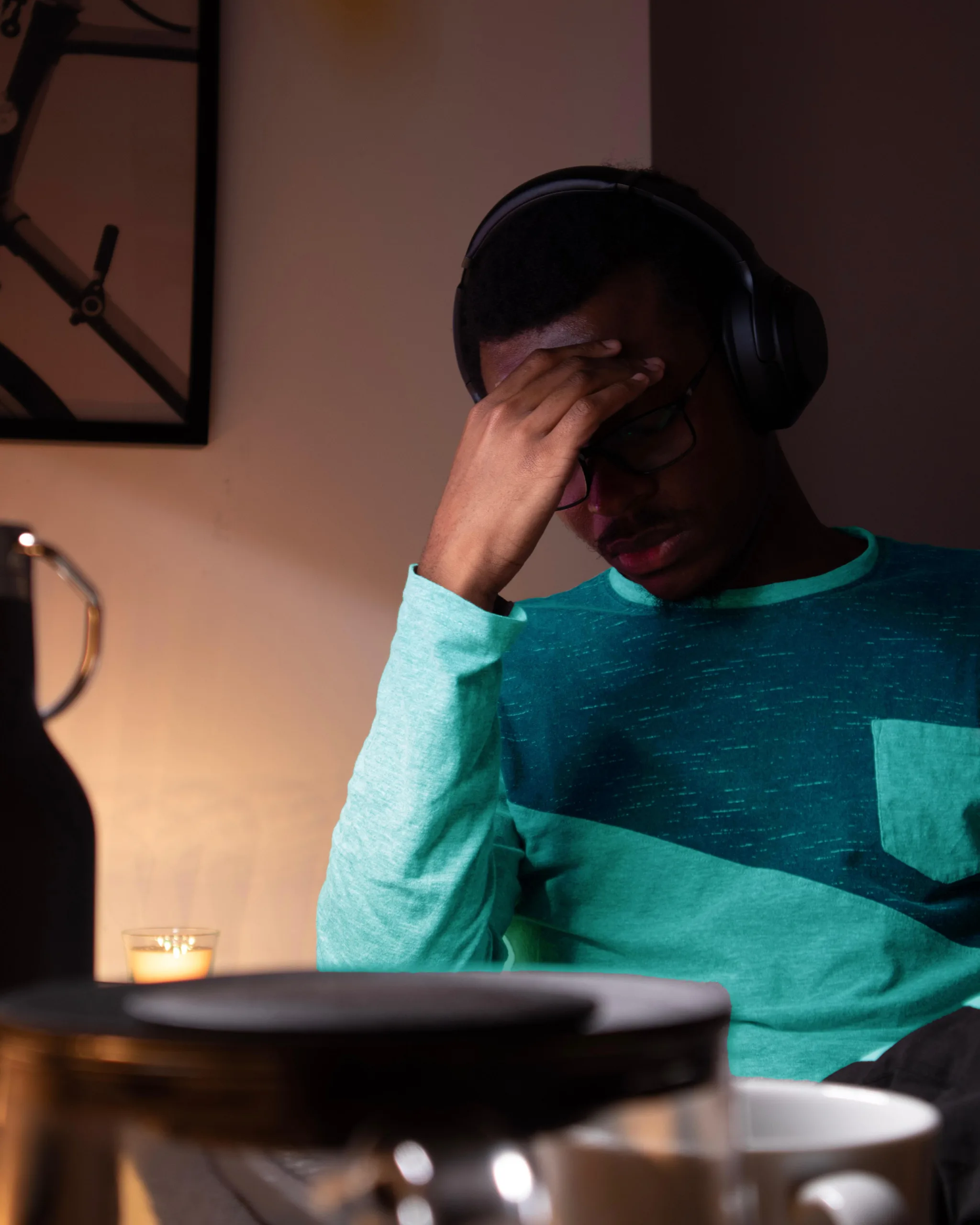 A stressed out man sitting at a laptop.